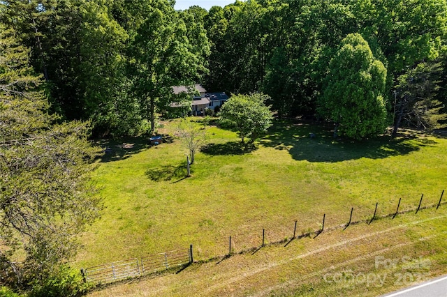 birds eye view of property with a view of trees and a rural view