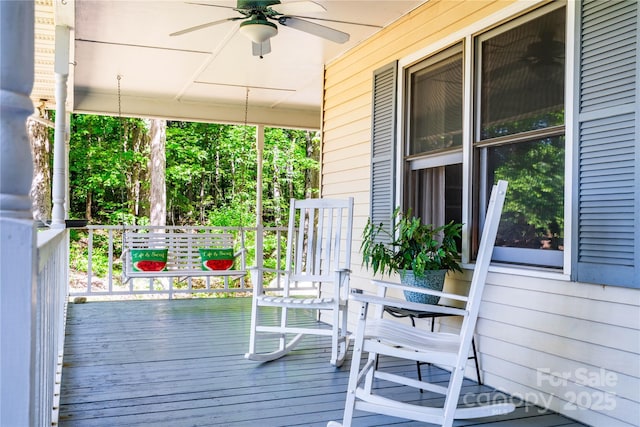 wooden terrace featuring ceiling fan and a porch
