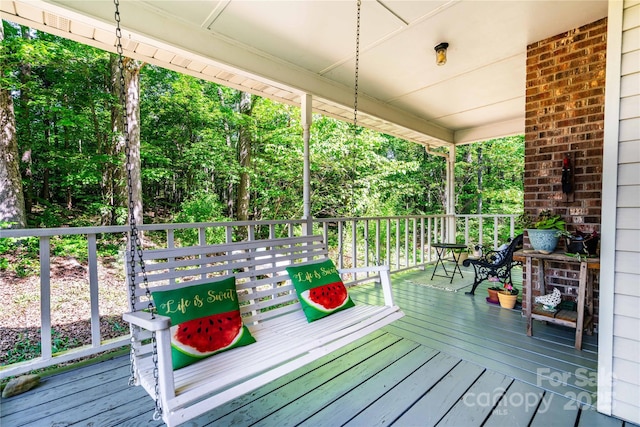wooden terrace featuring covered porch