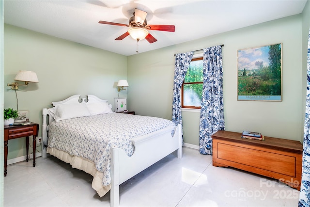 bedroom with ceiling fan and baseboards