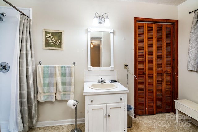 bathroom featuring a closet, curtained shower, and vanity