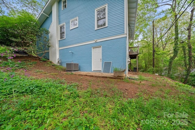 rear view of property with brick siding