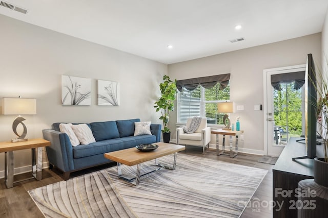 living room with visible vents, recessed lighting, baseboards, and wood finished floors