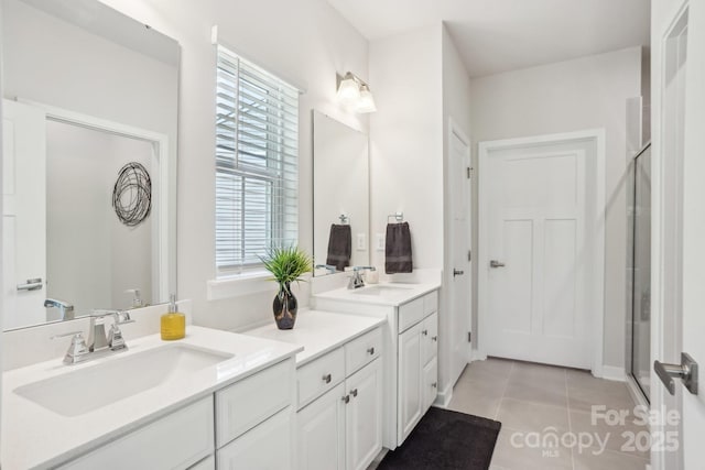 bathroom with tile patterned floors, a shower stall, and vanity