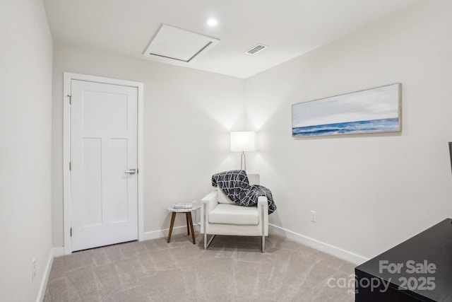 sitting room with carpet floors, baseboards, visible vents, and attic access