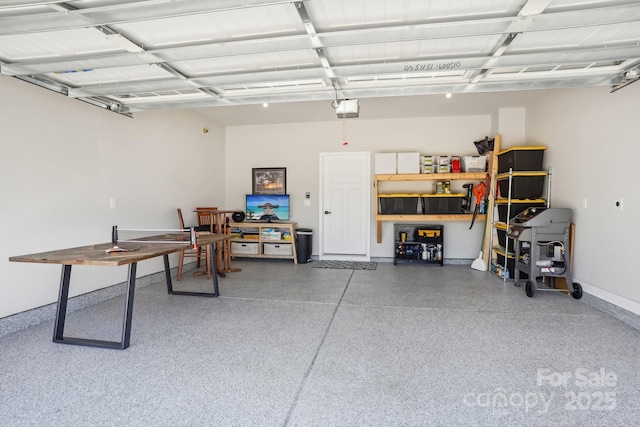 garage featuring baseboards and a garage door opener