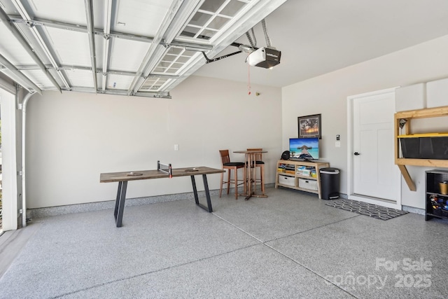 garage featuring baseboards and a garage door opener