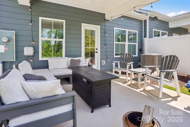 view of patio with fence, central AC, and outdoor lounge area