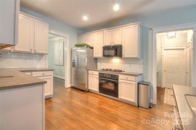 3009 Thayer Dr, Waxhaw, NC 28173 - kitchen with black appliances, backsplash, light wood finished floors, recessed lighting, and baseboards