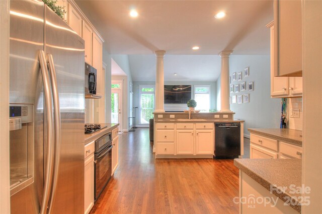3009 Thayer Dr, Waxhaw, NC 28173 - kitchen with black appliances, decorative columns, a sink, light wood-type flooring, and recessed lighting