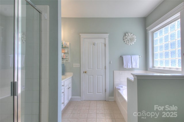 3009 Thayer Dr, Waxhaw, NC 28173 - full bathroom with tile patterned floors, a stall shower, vanity, a bath, and baseboards