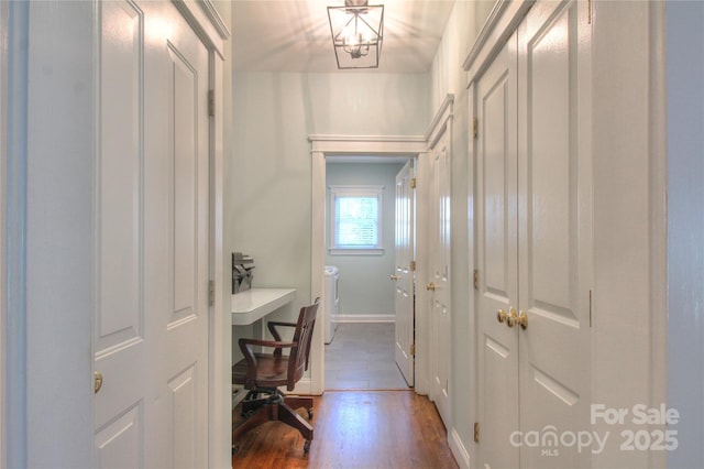 3009 Thayer Dr, Waxhaw, NC 28173 - hallway featuring wood finished floors, a desk, washing machine and clothes dryer, and baseboards