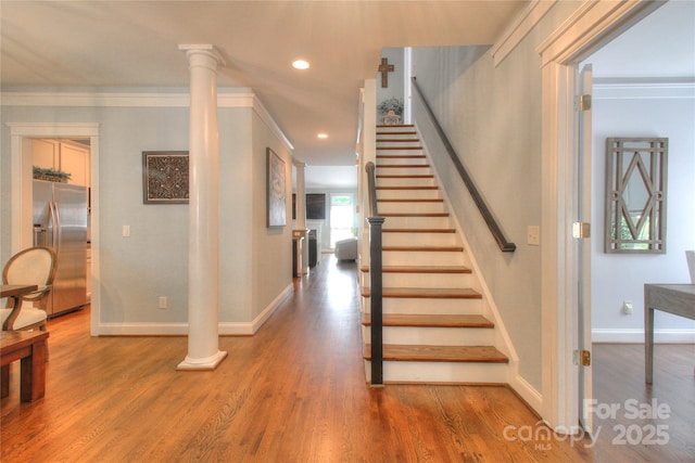3009 Thayer Dr, Waxhaw, NC 28173 - staircase with wood finished floors, baseboards, recessed lighting, ornamental molding, and decorative columns