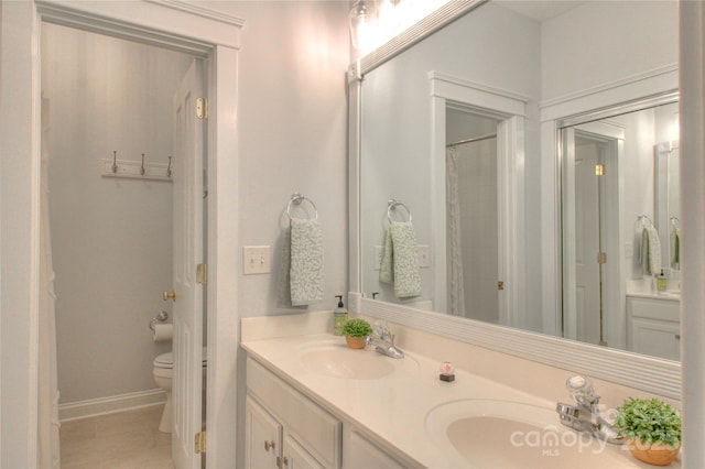 3009 Thayer Dr, Waxhaw, NC 28173 - full bathroom featuring toilet, double vanity, tile patterned flooring, and baseboards