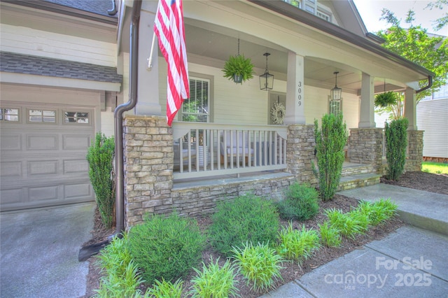 3009 Thayer Dr, Waxhaw, NC 28173 - view of exterior entry with a porch, stone siding, a garage, and a shingled roof