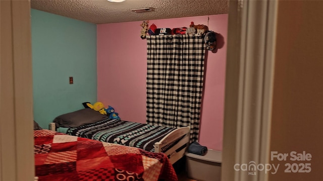 8524 Stoneman Pl, Charlotte, NC 28217 - bedroom with a textured ceiling and visible vents