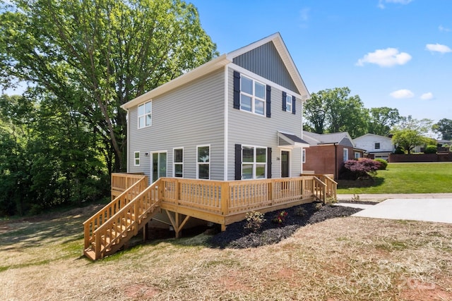 236 Elizabeth Ave, Forest City, NC 28043 - rear view of house with a lawn, stairway, board and batten siding, and a deck