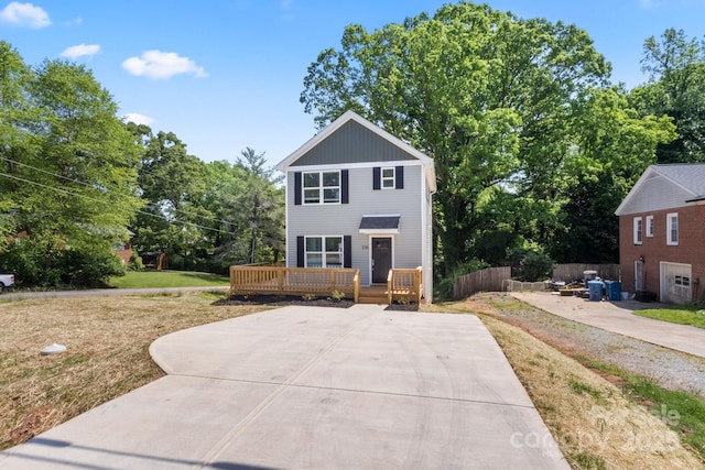 236 Elizabeth Ave, Forest City, NC 28043 - view of front of property featuring fence, a wooden deck, and a front lawn