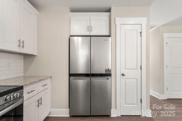 236 Elizabeth Ave, Forest City, NC 28043 - kitchen featuring backsplash, baseboards, appliances with stainless steel finishes, and wood finished floors