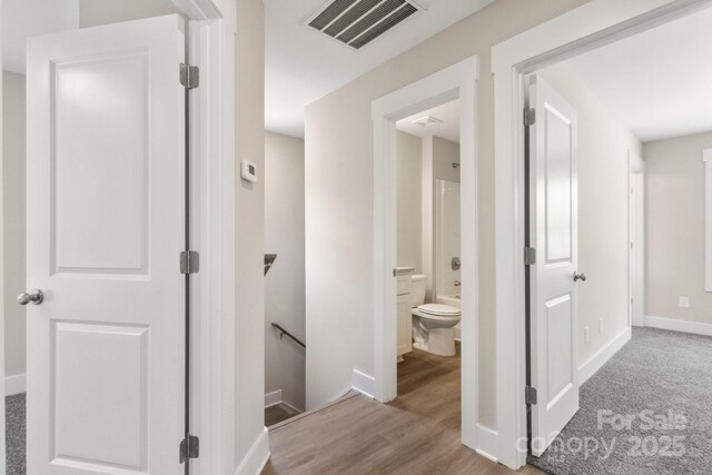236 Elizabeth Ave, Forest City, NC 28043 - corridor featuring baseboards, an upstairs landing, wood finished floors, and visible vents