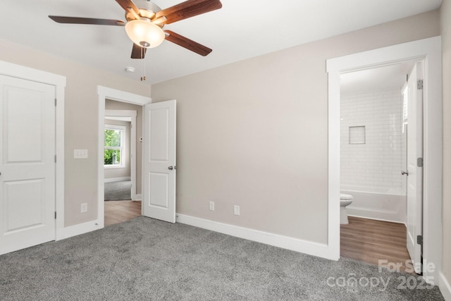 236 Elizabeth Ave, Forest City, NC 28043 - unfurnished bedroom featuring baseboards, ceiling fan, carpet flooring, and ensuite bath
