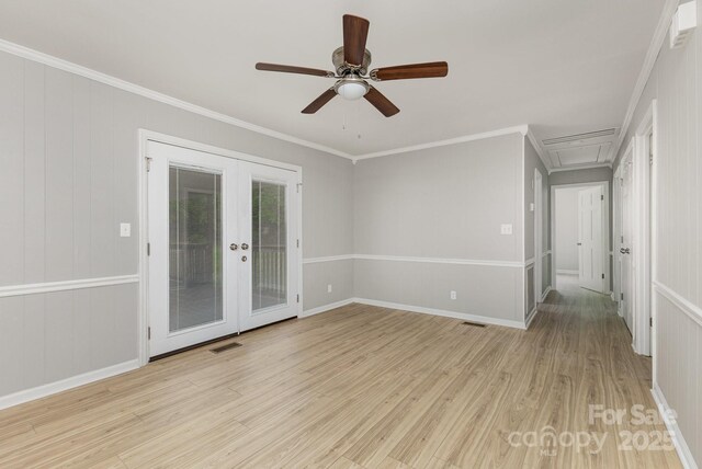 spare room with crown molding, a ceiling fan, french doors, and light wood finished floors