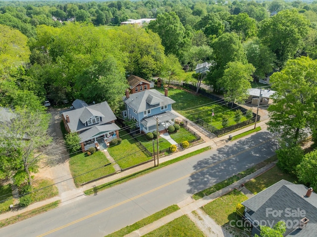 bird's eye view with a wooded view