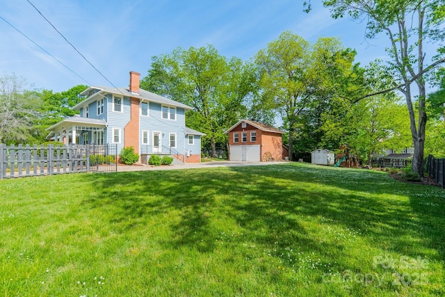 exterior space with a chimney, a storage shed, fence, an outdoor structure, and a front lawn