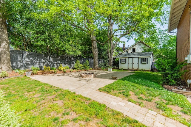 view of yard featuring a patio, an outdoor structure, and fence