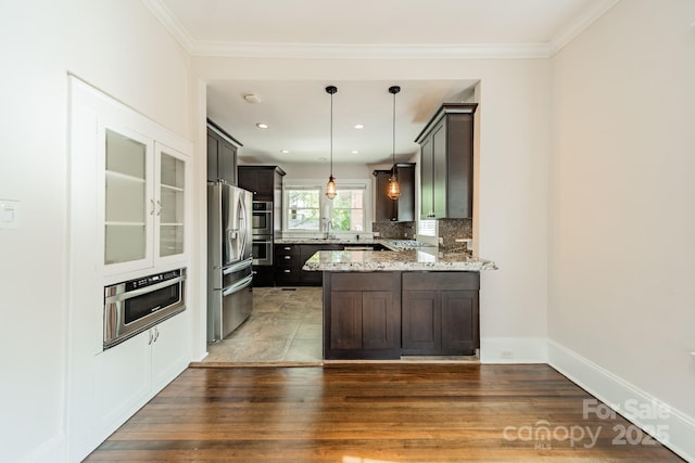 kitchen featuring pendant lighting, a peninsula, wood finished floors, light stone countertops, and stainless steel refrigerator with ice dispenser