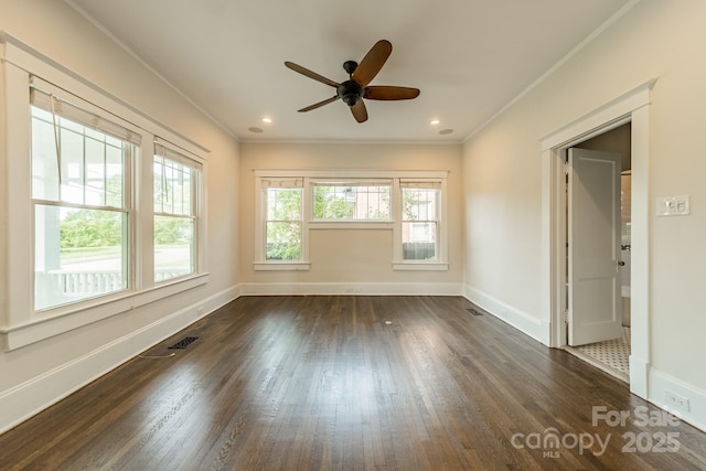 spare room with crown molding, baseboards, ceiling fan, and dark wood-style flooring
