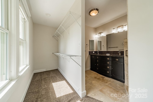 walk in closet featuring a sink