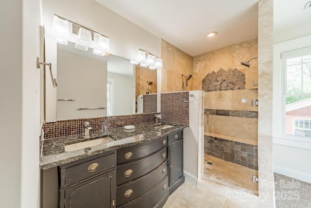 full bath with a shower stall, a sink, and a wealth of natural light