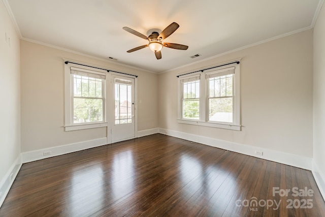 spare room featuring a ceiling fan, baseboards, dark wood finished floors, and visible vents