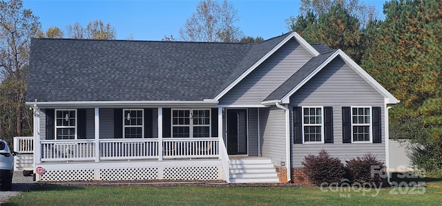 ranch-style house with a shingled roof and covered porch
