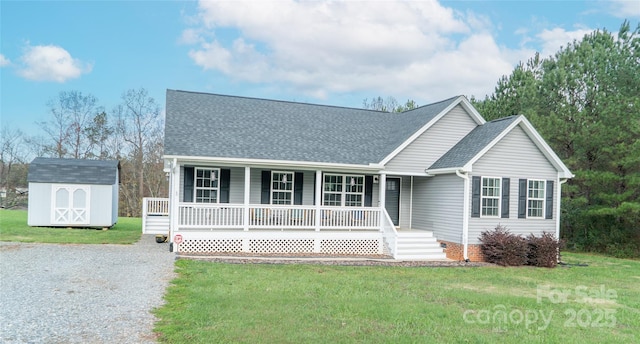 view of front facade with a porch, an outdoor structure, a front yard, and a storage shed