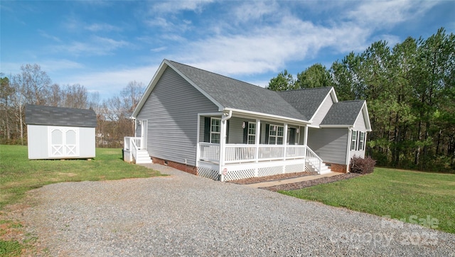 view of front of home with a porch, a storage shed, crawl space, and a front lawn