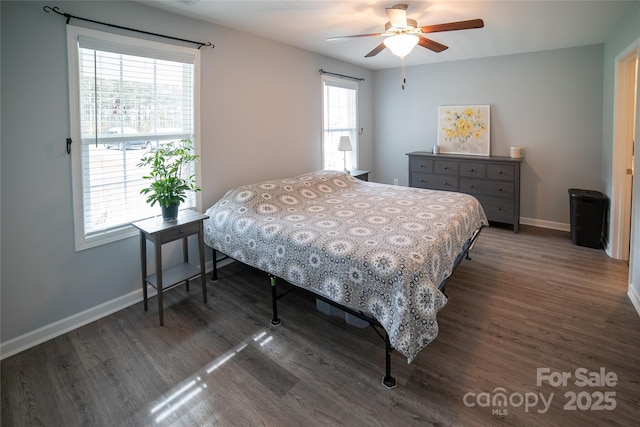 bedroom featuring baseboards, wood finished floors, and a ceiling fan
