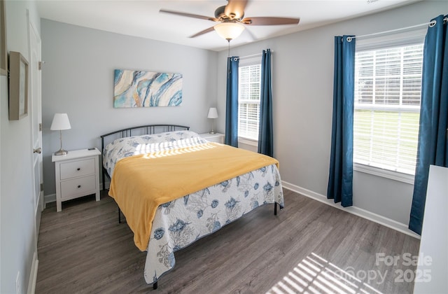 bedroom with a ceiling fan, wood finished floors, and baseboards