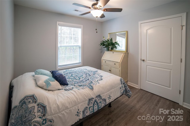 bedroom with baseboards, visible vents, wood finished floors, and ceiling fan