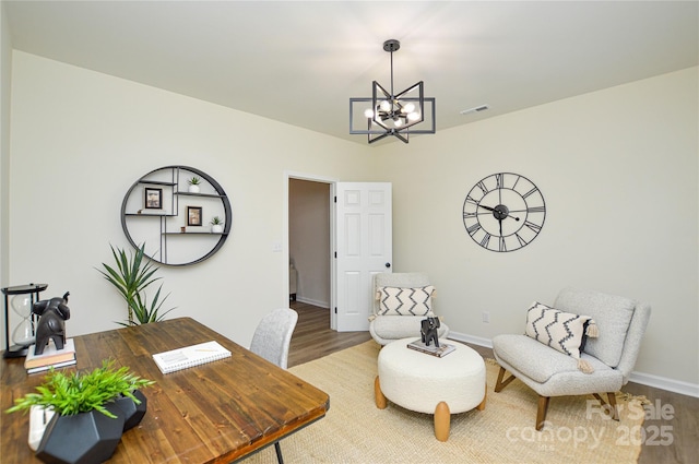 office featuring a chandelier, wood finished floors, and baseboards