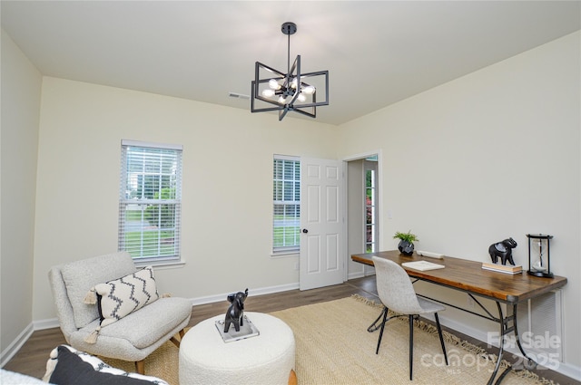 office space with a chandelier, wood finished floors, and baseboards