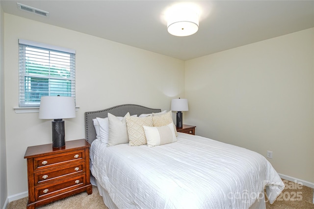 bedroom featuring light colored carpet and baseboards