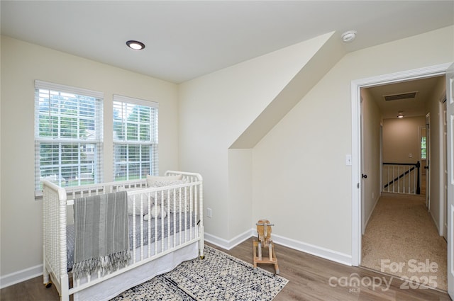 bedroom with baseboards and wood finished floors