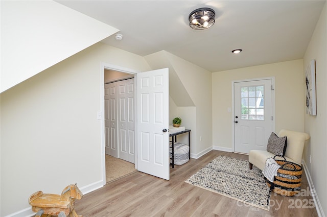entrance foyer with wood finished floors and baseboards