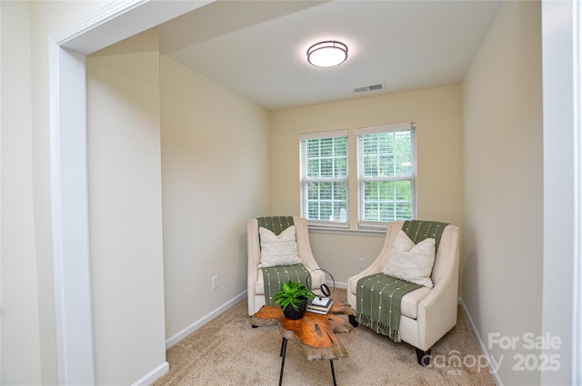 sitting room featuring baseboards and carpet