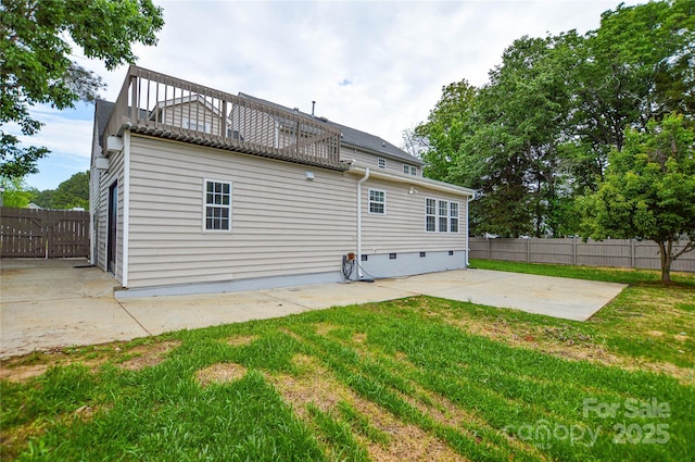 rear view of property featuring a patio and crawl space