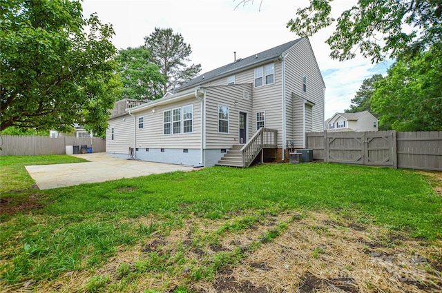 back of house with a patio and a gate