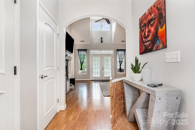 14807 Middlesborough Dr, Matthews, NC 28104 - entryway with light wood-type flooring, arched walkways, french doors, and a high ceiling