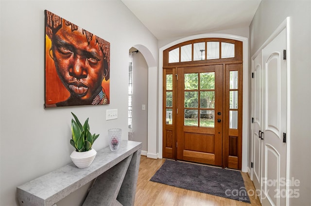 14807 Middlesborough Dr, Matthews, NC 28104 - entryway featuring arched walkways, light wood-type flooring, and baseboards